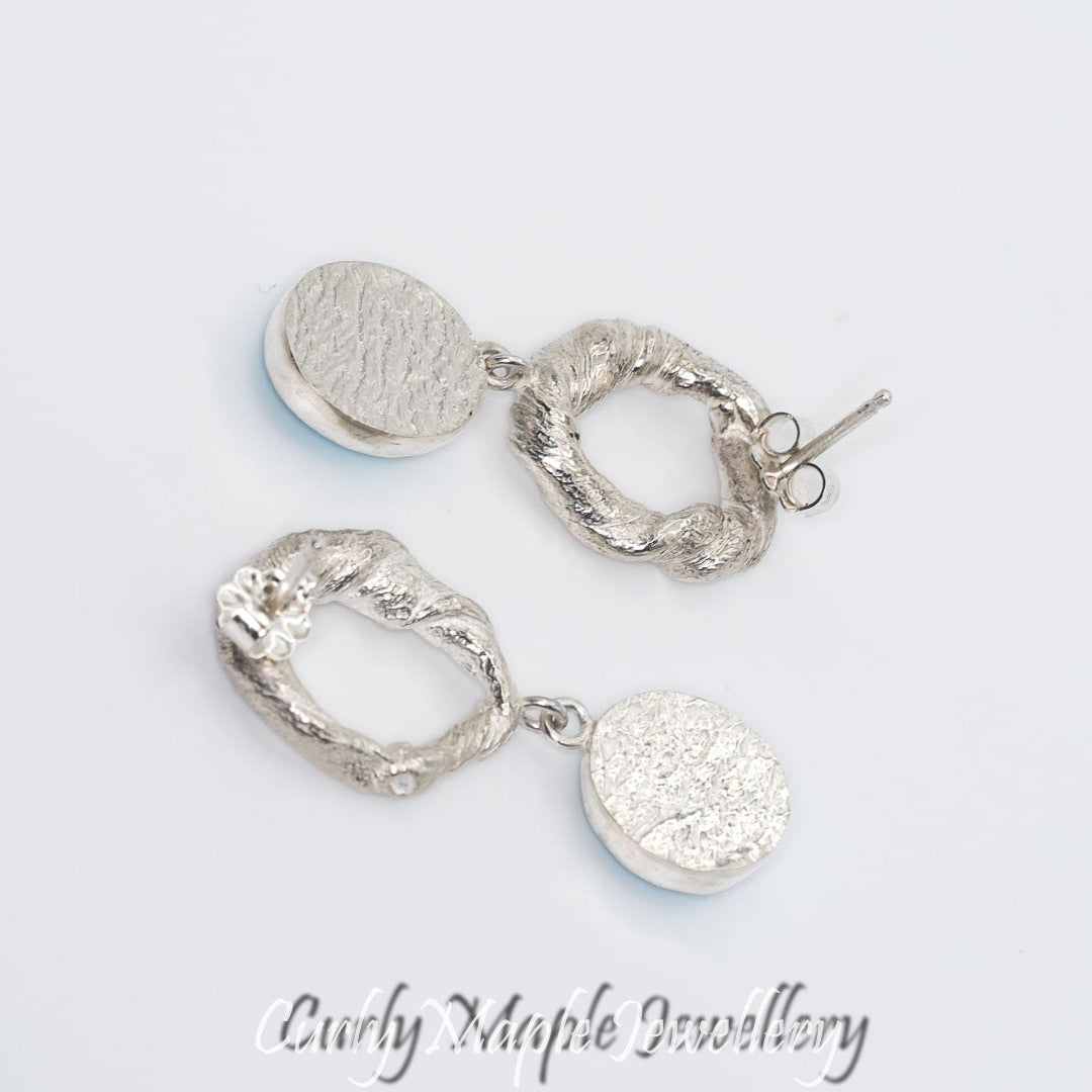Showing the backs of the Organic Silver Dangle Earrings