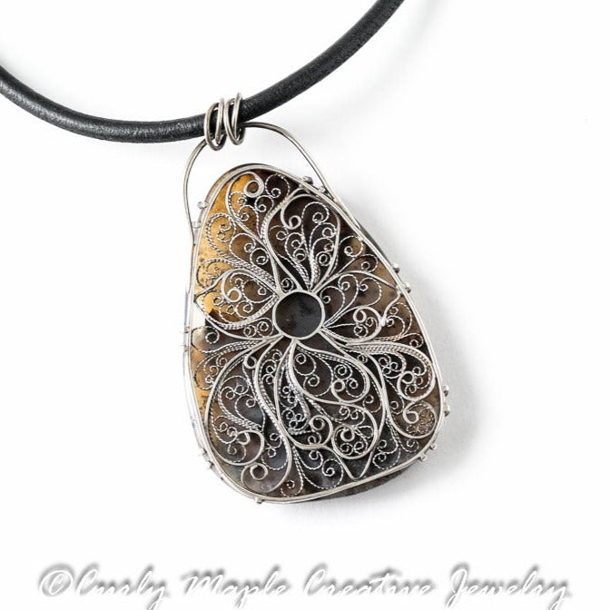 The back of the Dendritic Agate Garnet Filigree Necklace
