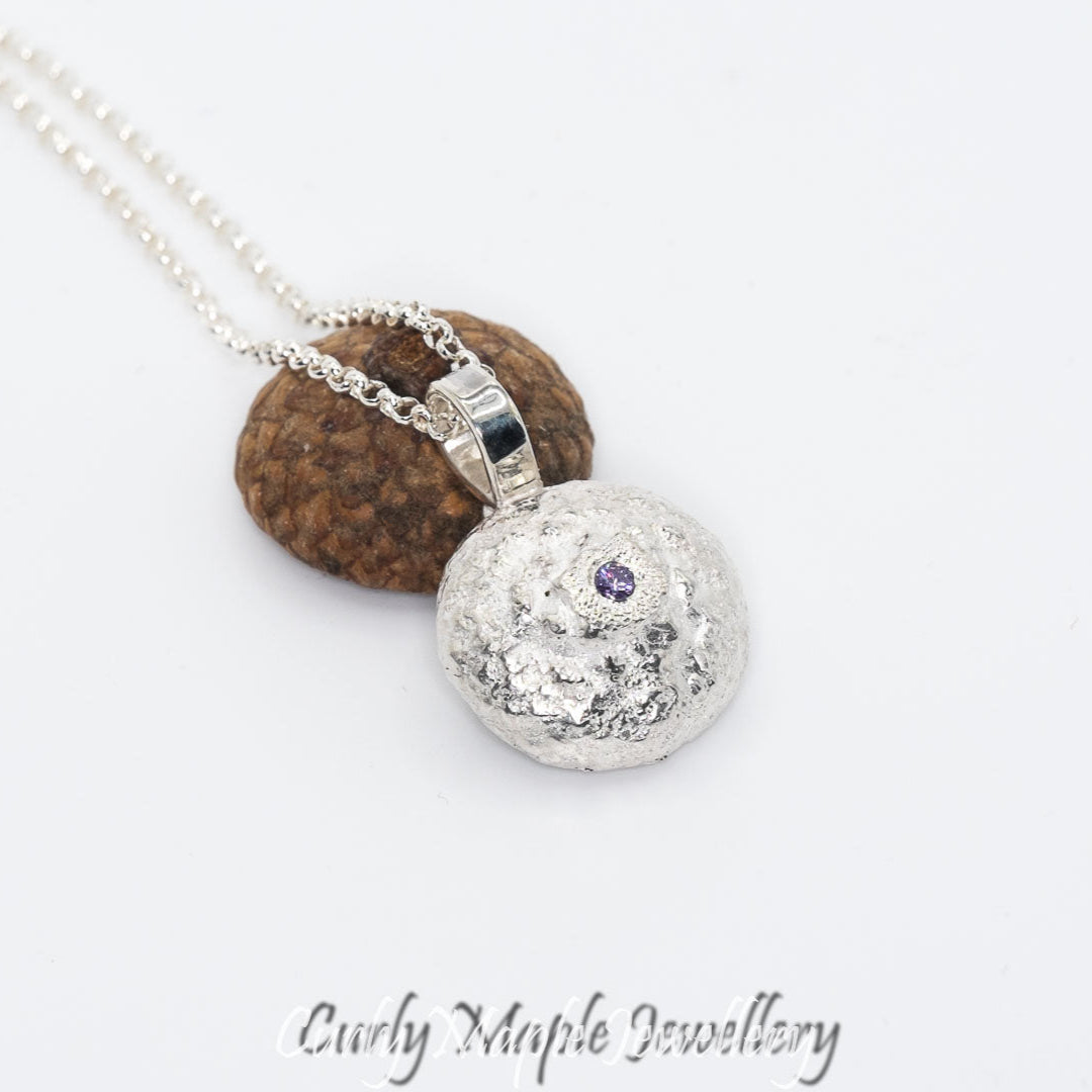the back of the Organic Acorn Cap Amethyst Pendant