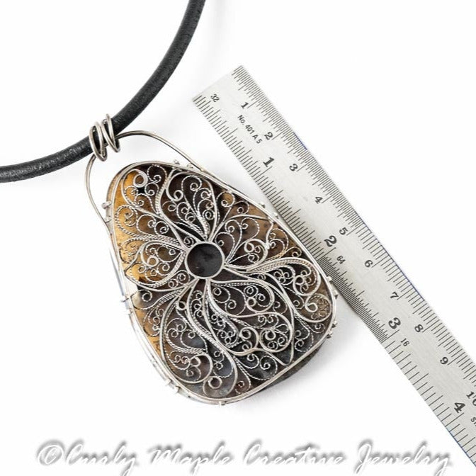 The back of the Dendritic  Agate Garnet Filigree Necklace with a ruler for scale