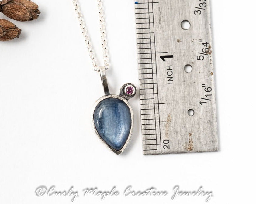 Teardrop Kyanite and Garnet Silver Pendant Necklace with a ruler for scale