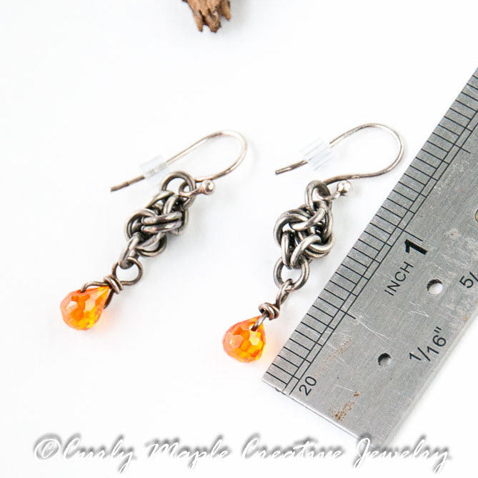 Love Knot Silver Earrings with Orange CZ drop with a ruler