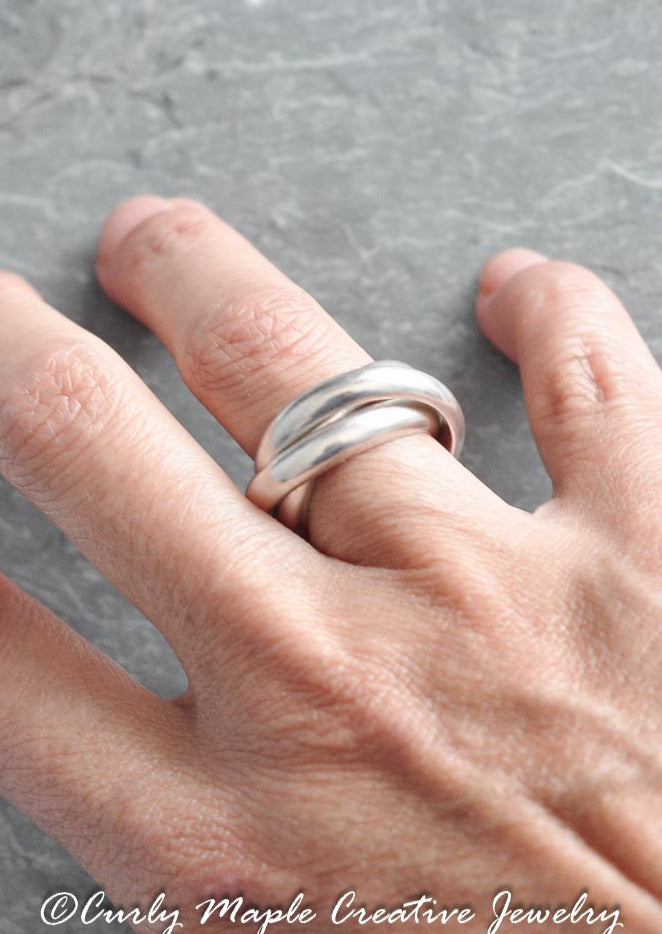 Chunky Interlocking Sterling Silver Ring on a woman's right finger ring